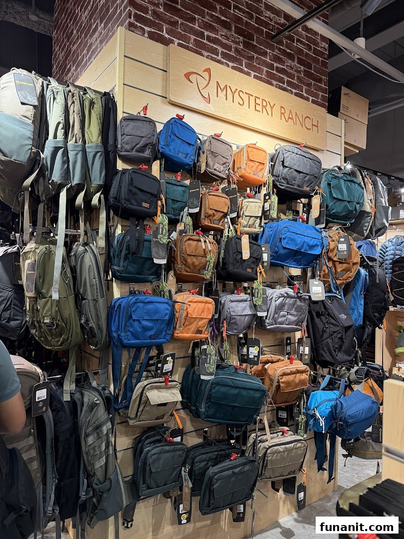 A wide selection of durable Mystery Ranch bags and backpacks displayed in an outdoor gear shop.