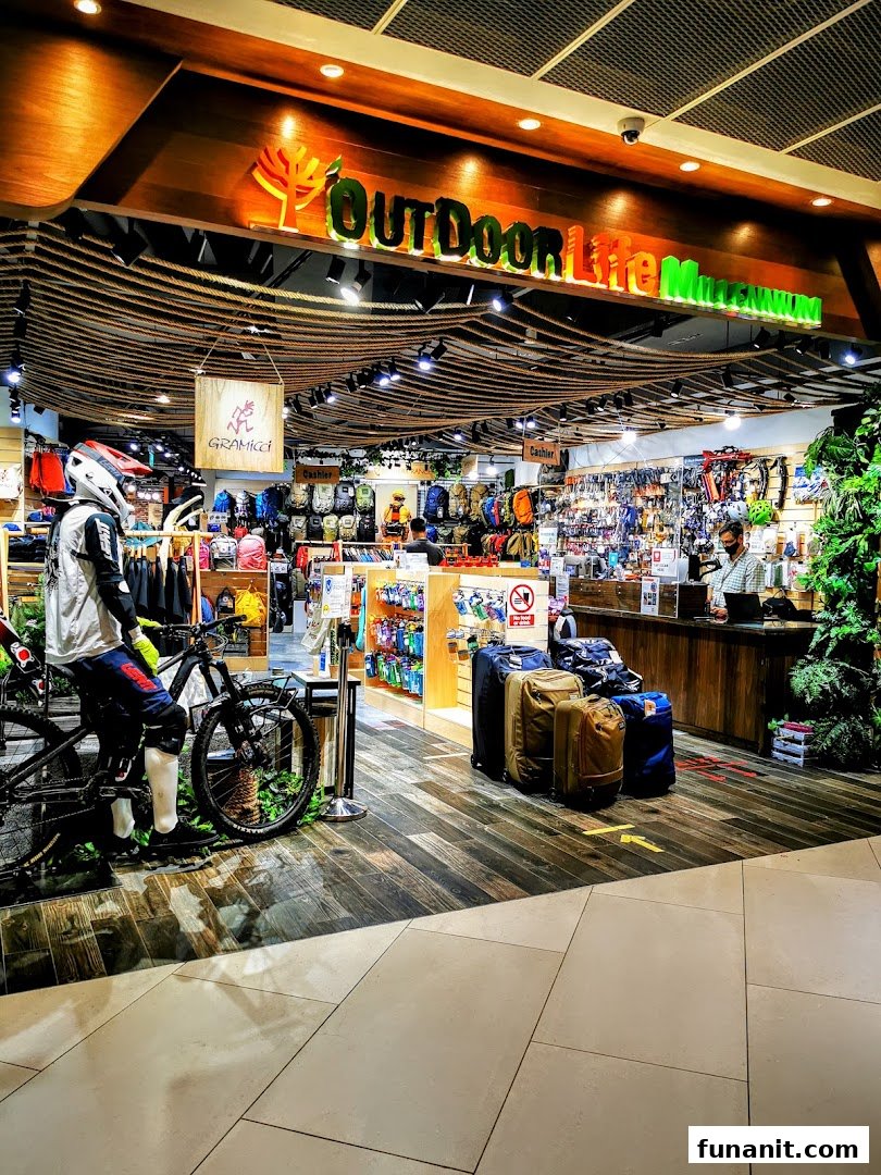 Vibrant entrance of Outdoor Life store showcasing adventure gear, bicycles, and travel essentials.