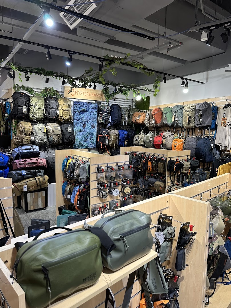 Interior view of Outdoor Life shop showcasing a wide array of backpacks and outdoor accessories.