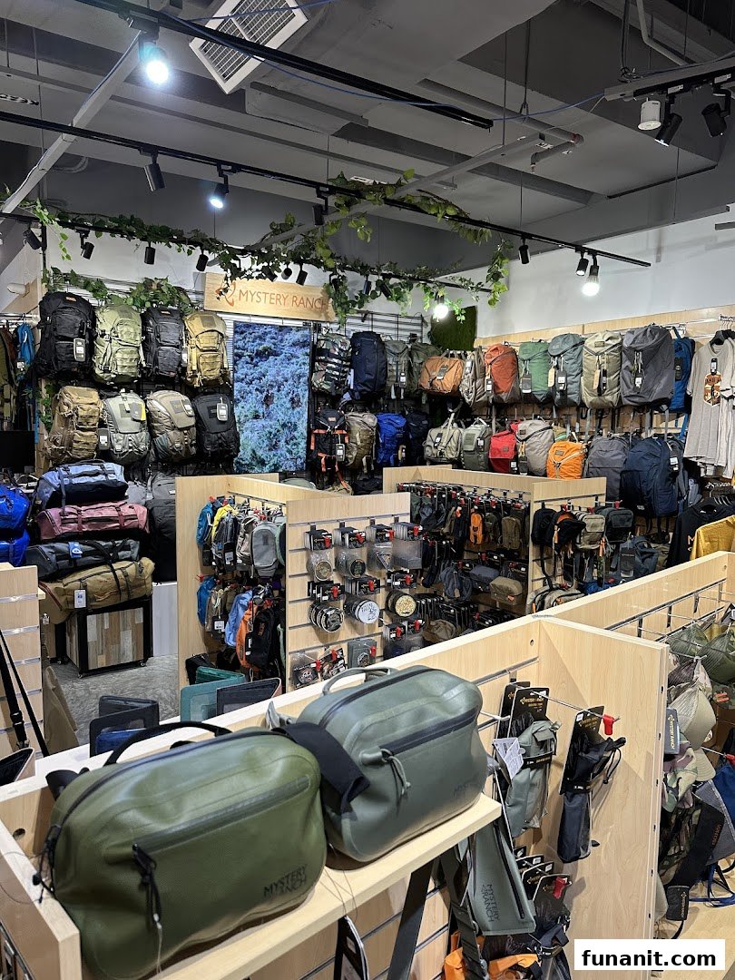 Interior view of Outdoor Life shop showcasing a wide array of backpacks and outdoor accessories.