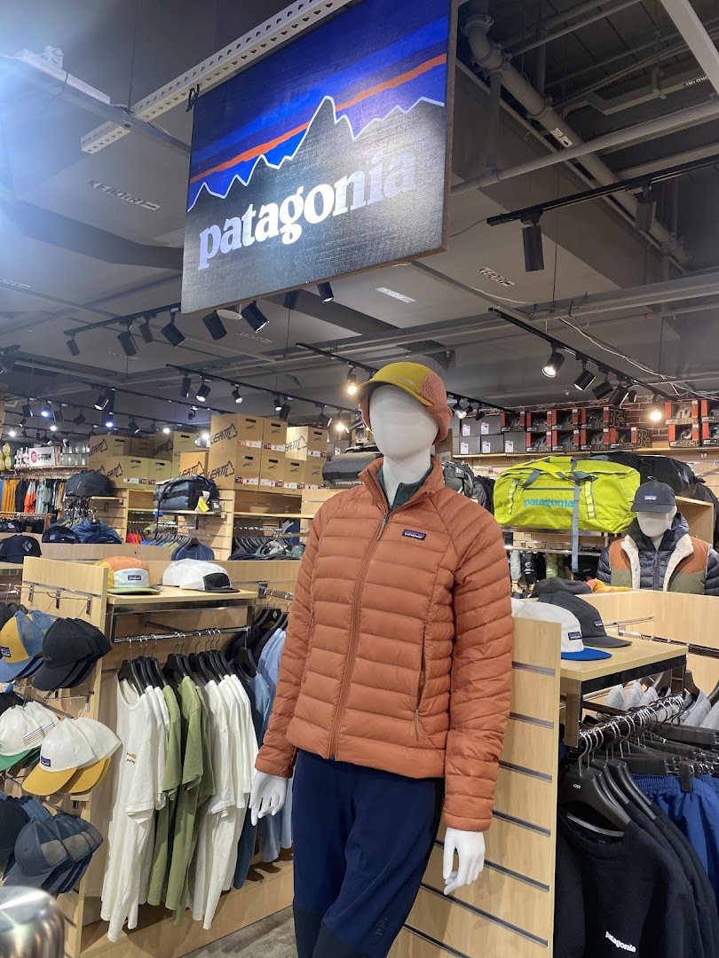 Mannequin displaying outdoor apparel and gear inside Outdoor Life shop, featuring Patagonia products.