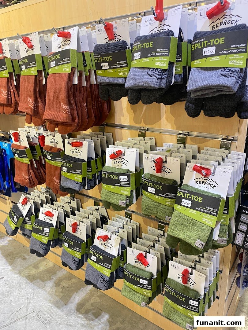 Rows of performance split-toe socks in various colors displayed on a retail shelf.