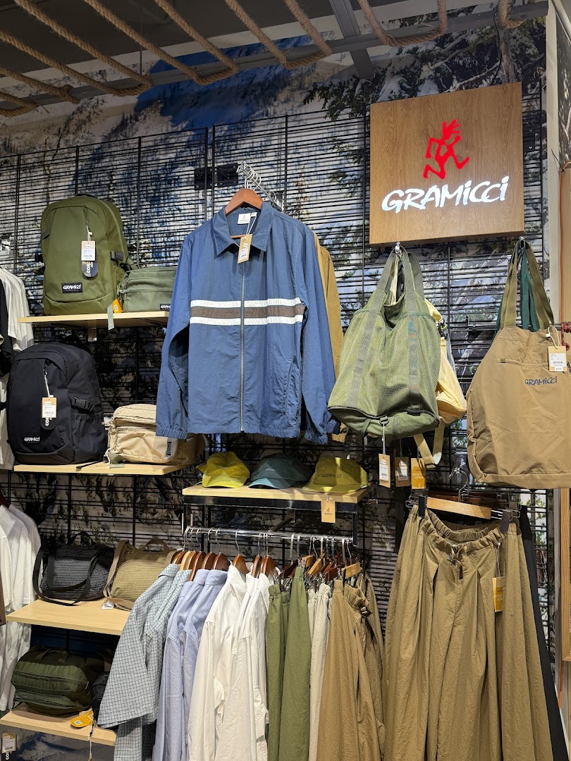 Interior shot of Outdoor Life showcasing Gramicci apparel and accessories like jackets, shirts, pants, and bags.