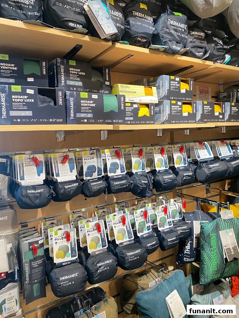 Shelves filled with Therm-a-Rest sleeping pads and pillows for outdoor adventures.