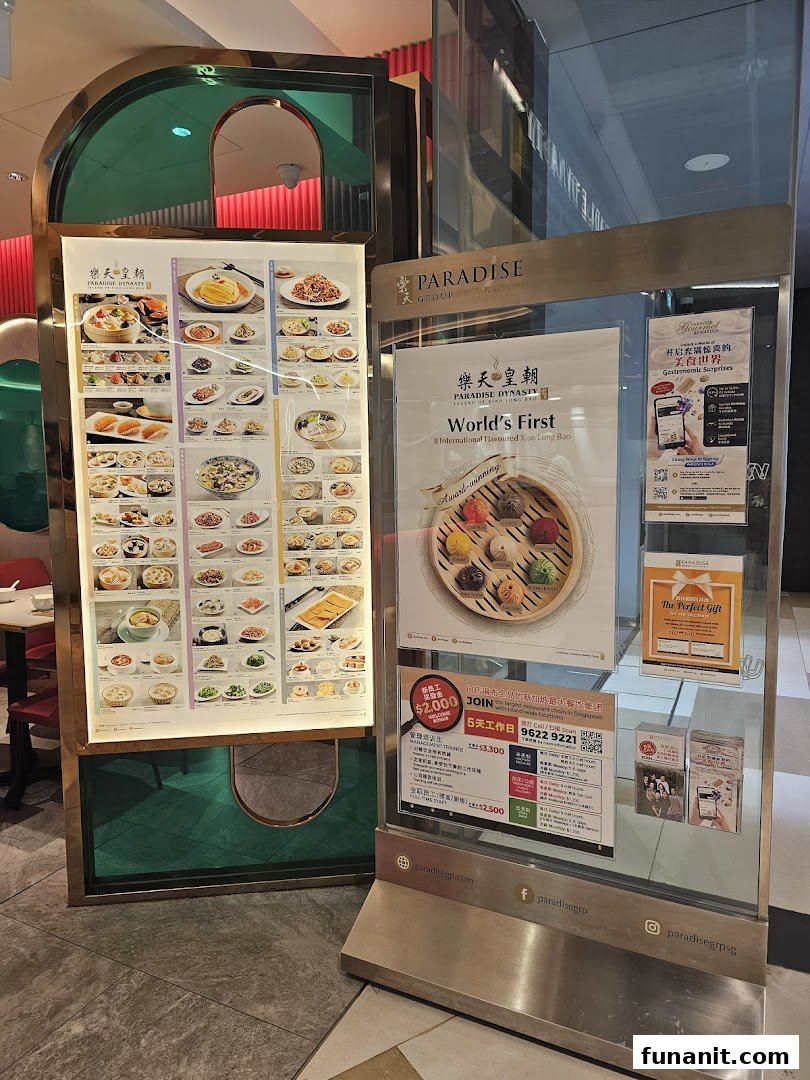 Entrance display of Paradise Dynasty showcasing signature dishes and promotional information.