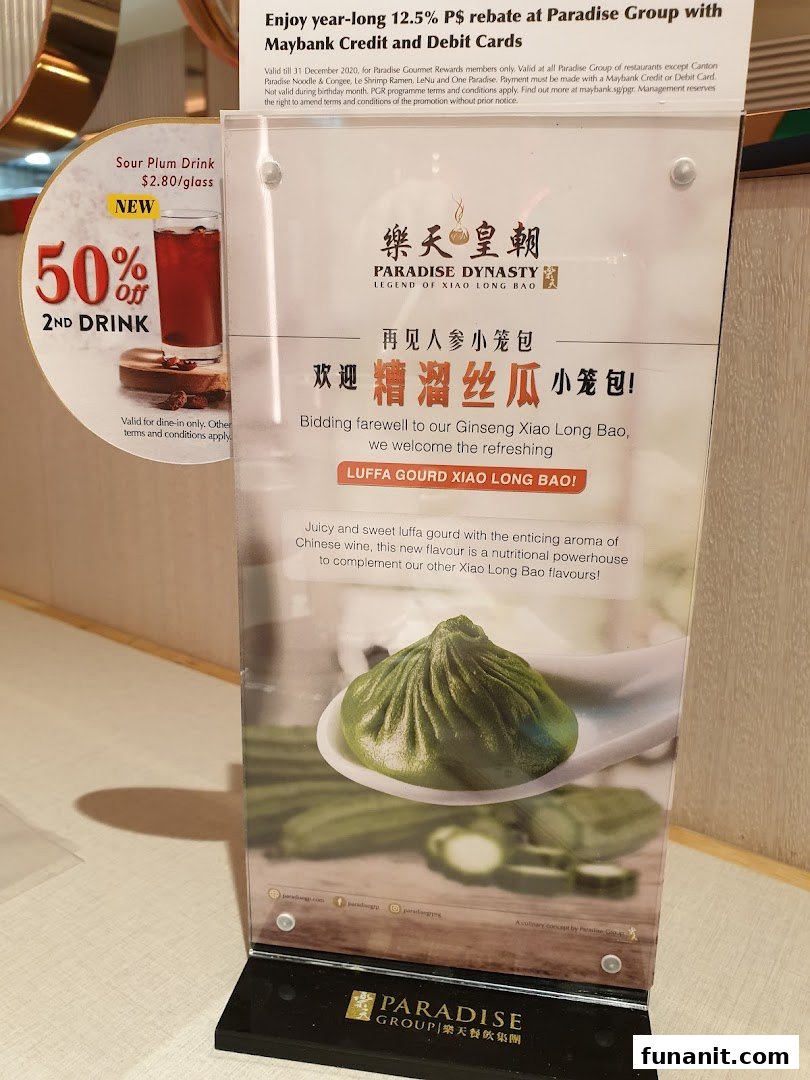 A table display featuring a new Luffa Gourd Xiao Long Bao promotion and a 50% off second drink offer.