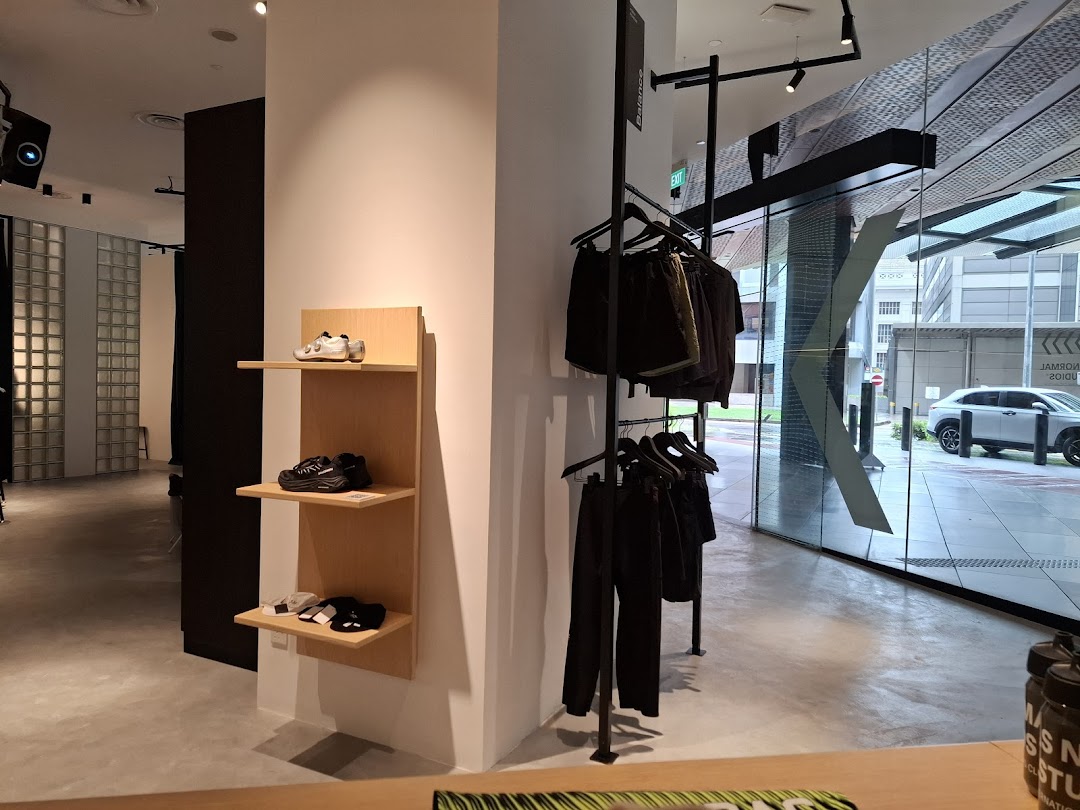 Interior view of Pas Normal Studios Singapore, showcasing cycling apparel, footwear, and accessories.
