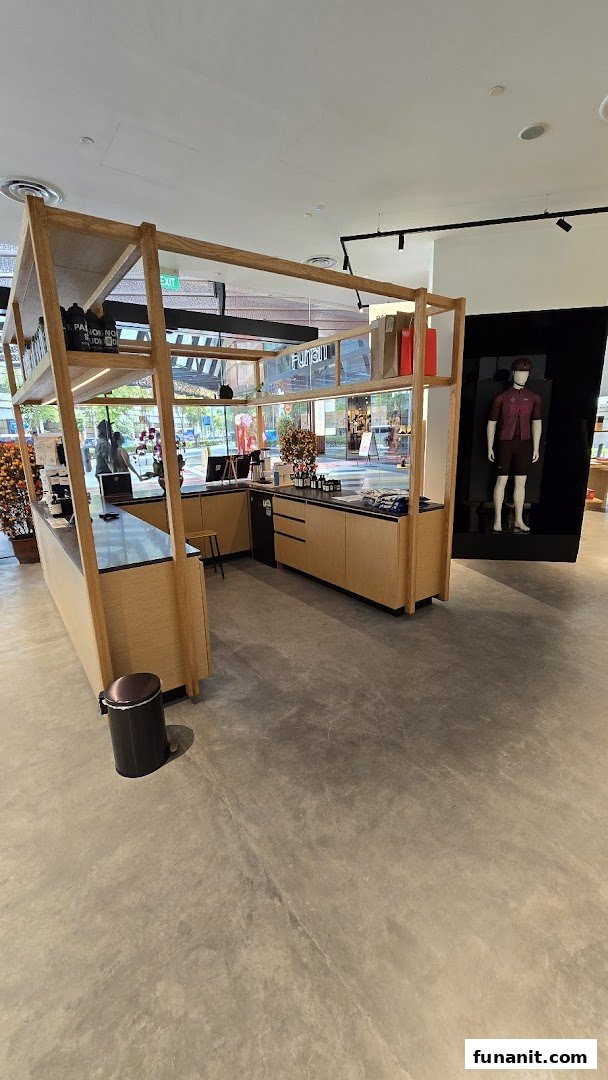 Interior view of Pas Normal Studios, featuring a modern counter, product displays, and a mannequin.