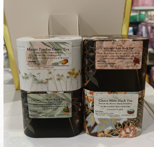 Close-up of four beautifully designed tea tins showcasing unique tea blends from Pétale Tea.