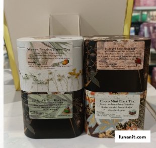 Close-up of four beautifully designed tea tins showcasing unique tea blends from Pétale Tea.