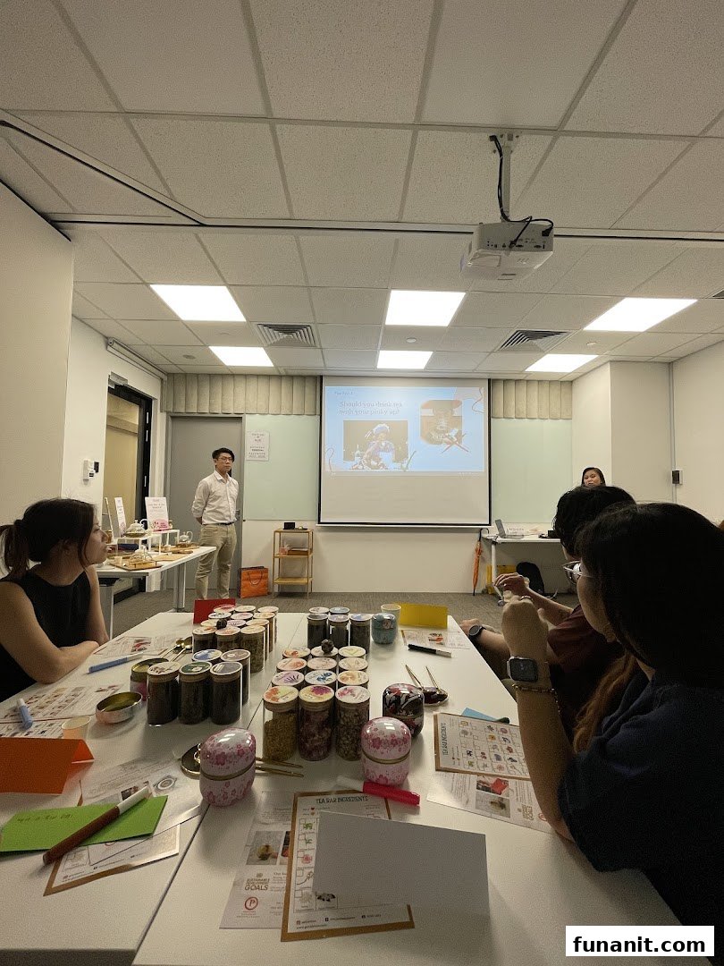 Attendees participate in a tea blending workshop with various ingredients and a presentation.
