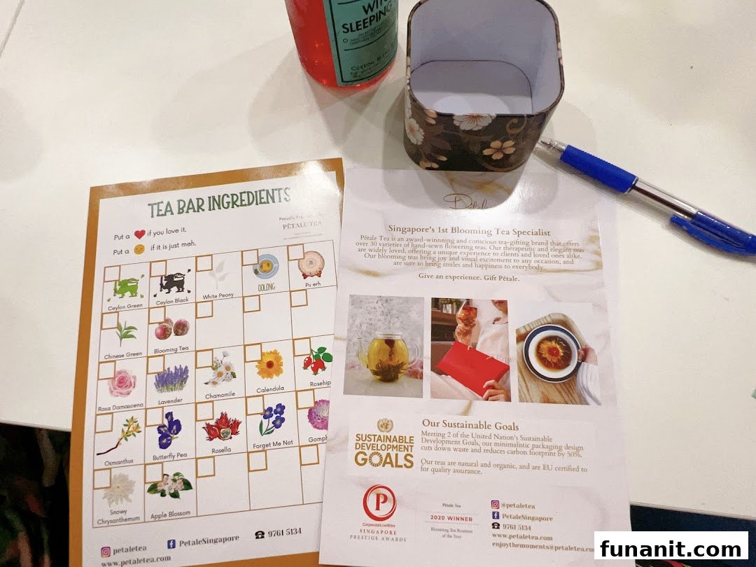 A table displays Pétale Tea's 'Tea Bar Ingredients' chart, promotional flyer, a pen, and a tea box.