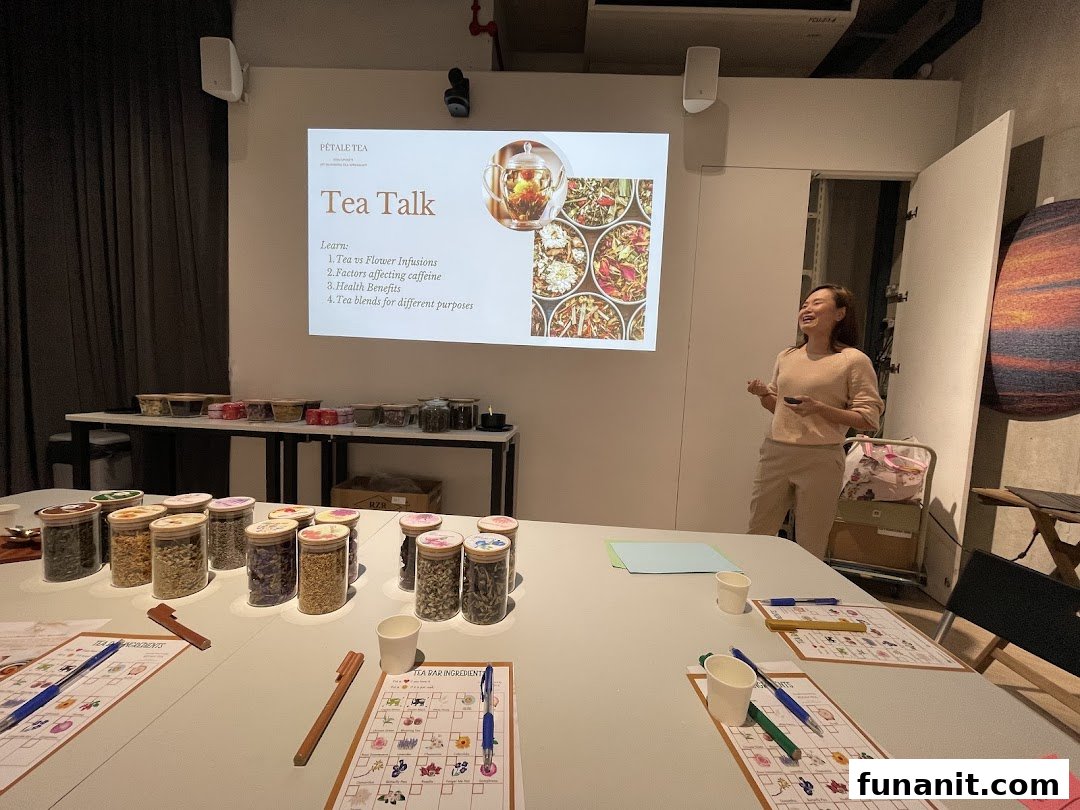 An instructor leads a 'Tea Talk' workshop at Pétale Tea, surrounded by various tea ingredients and learning materials.