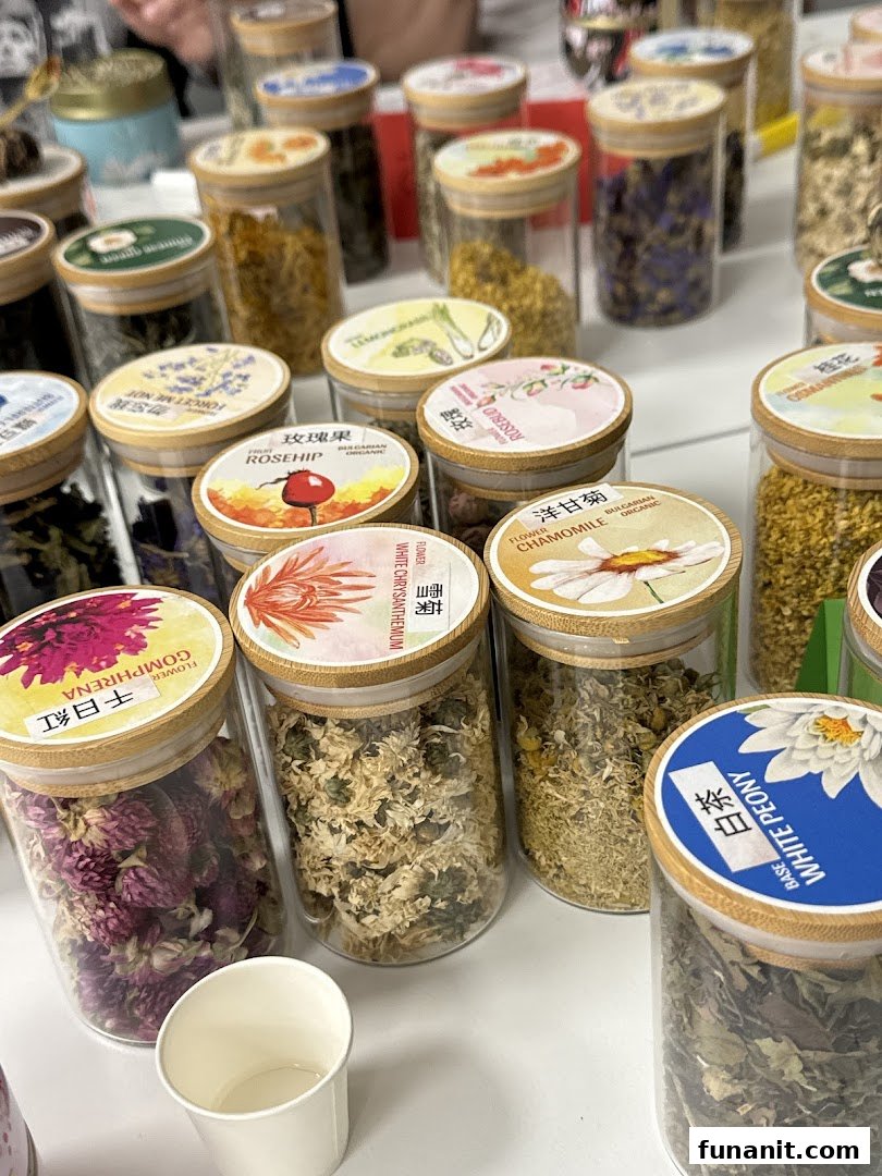 Close-up of various glass jars filled with dried flowers and herbs for tea.
