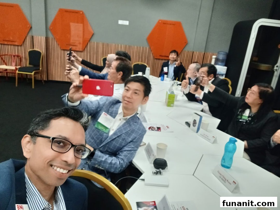 A group of business professionals actively participating in a meeting, with several individuals taking photos.