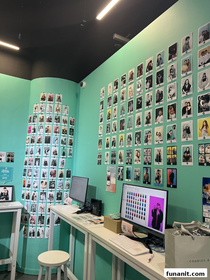 Interior of a self-photo studio with walls adorned by customer photos, desks, and computers.