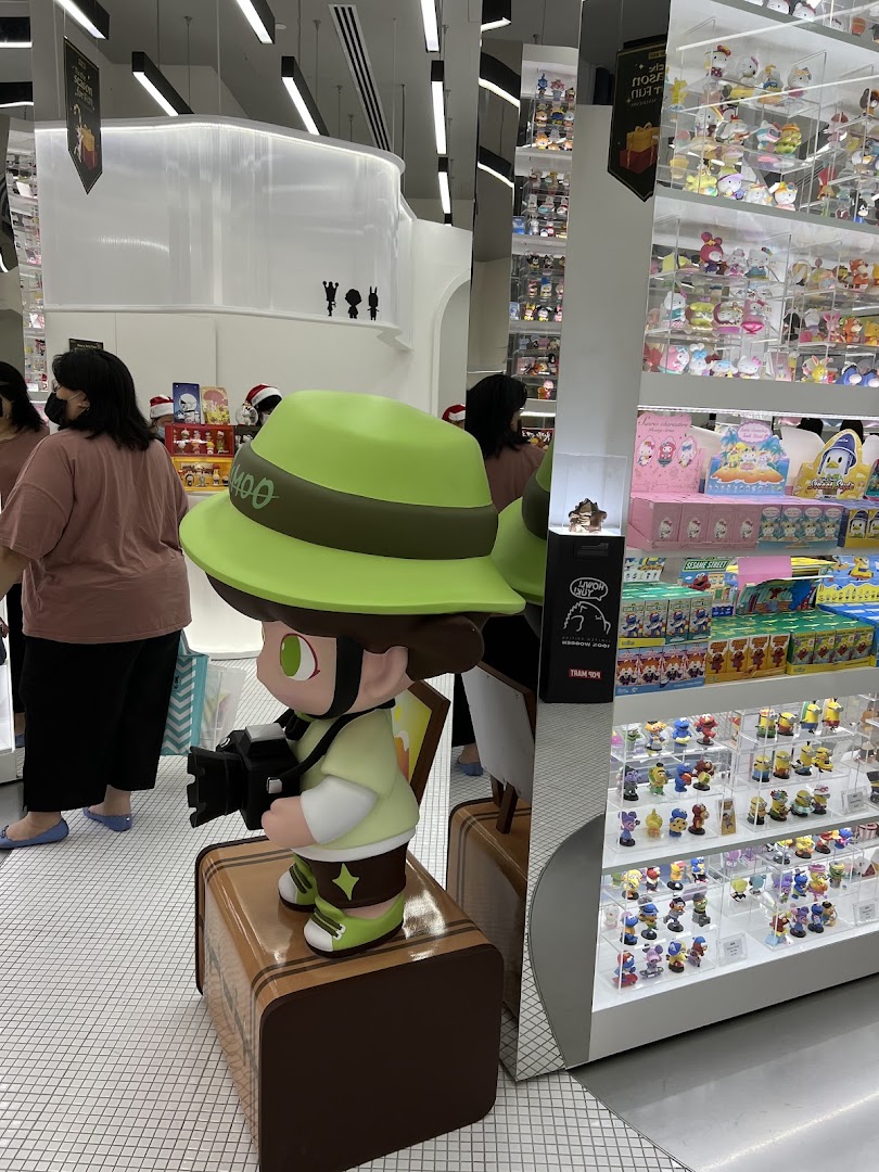 Interior view of POP MART Funan, featuring a large display figure and shelves filled with collectible toys.
