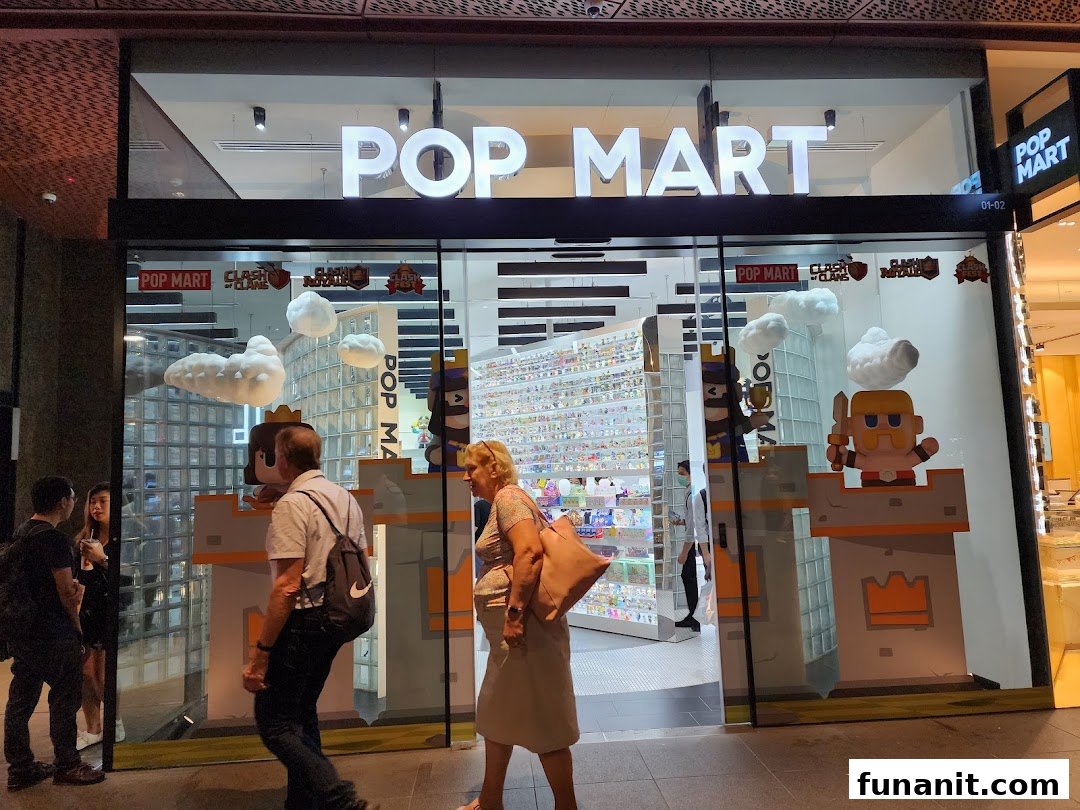 The brightly lit POP MART shop entrance features a vibrant display and people walking by.