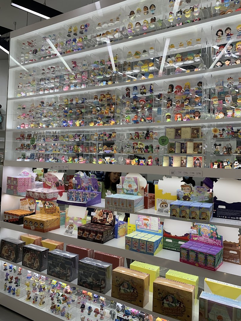 Shelves filled with a vast collection of colorful collectible figurines and blind boxes at POP MART.