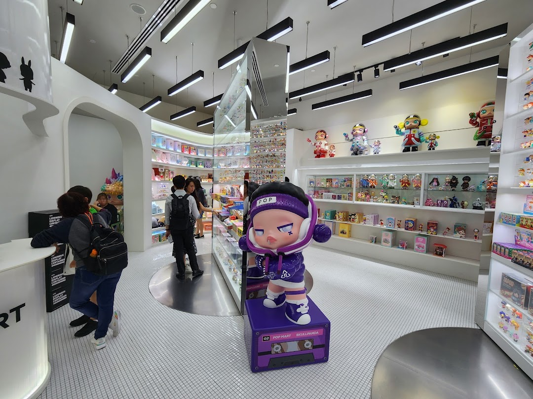 Interior view of POP MART Funan, showcasing collectible art toys, figurines, and a large Skullpanda statue.
