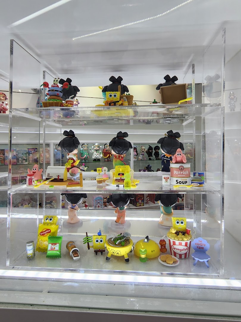 A clear display case showcasing various Spongebob Squarepants collectible figures and accessories inside POP MART.