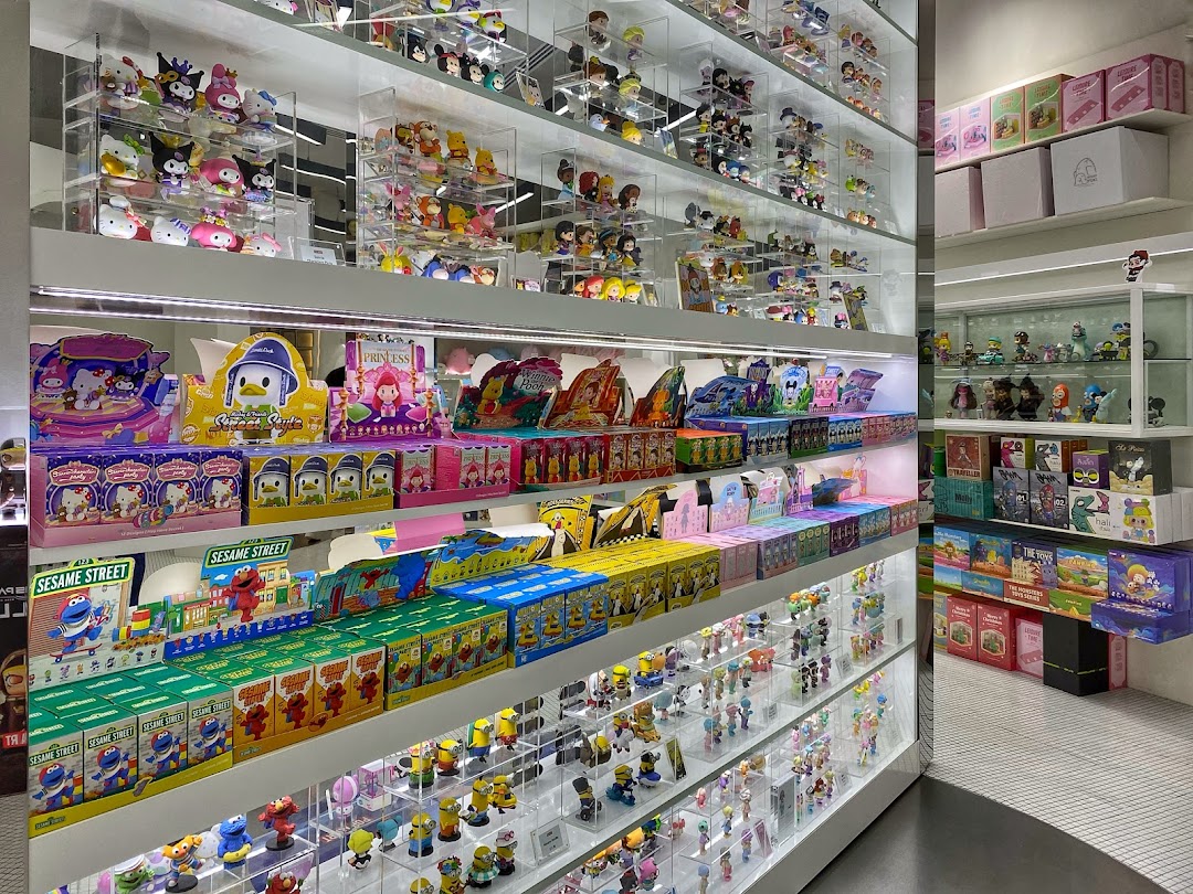 Shelves filled with diverse collectible toys, blind boxes, and character merchandise at POP MART.