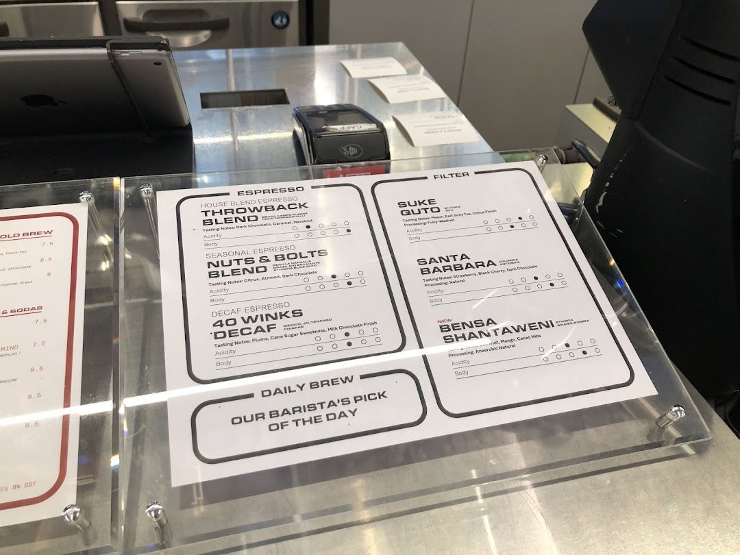 A detailed coffee menu display showcasing various espresso and filter coffee options with tasting notes.