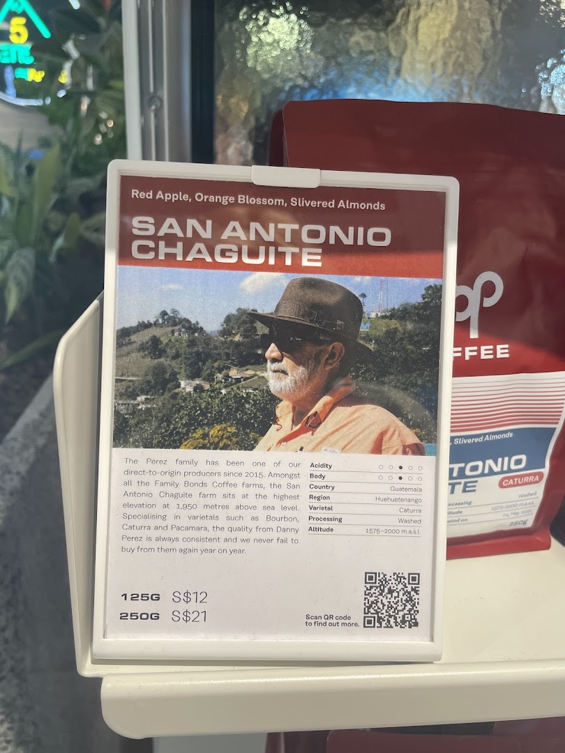 A detailed display card showcasing San Antonio Chaguite coffee beans with origin, tasting notes, and pricing.
