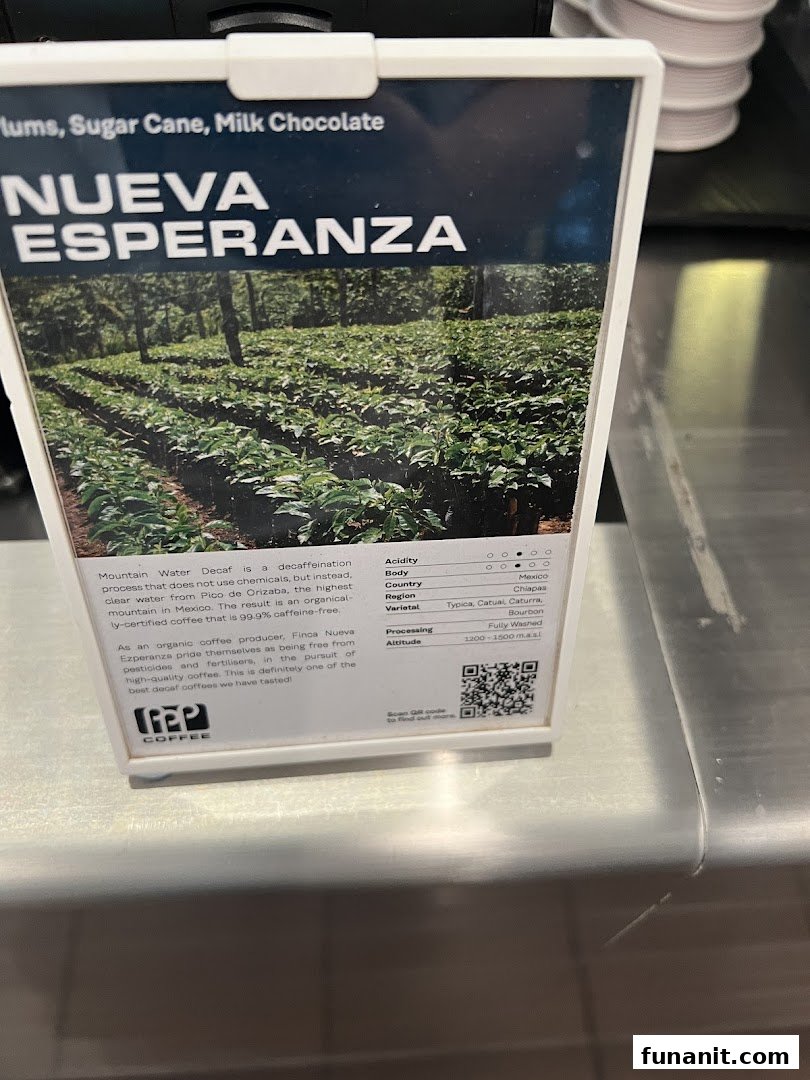 A display card at PPP Coffee detailing Nueva Esperanza decaf coffee beans with origin and flavor notes.
