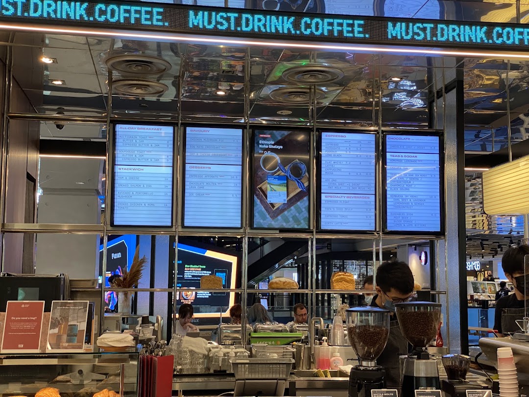 Digital menu boards displaying coffee, breakfast, and snack options at PPP Coffee.