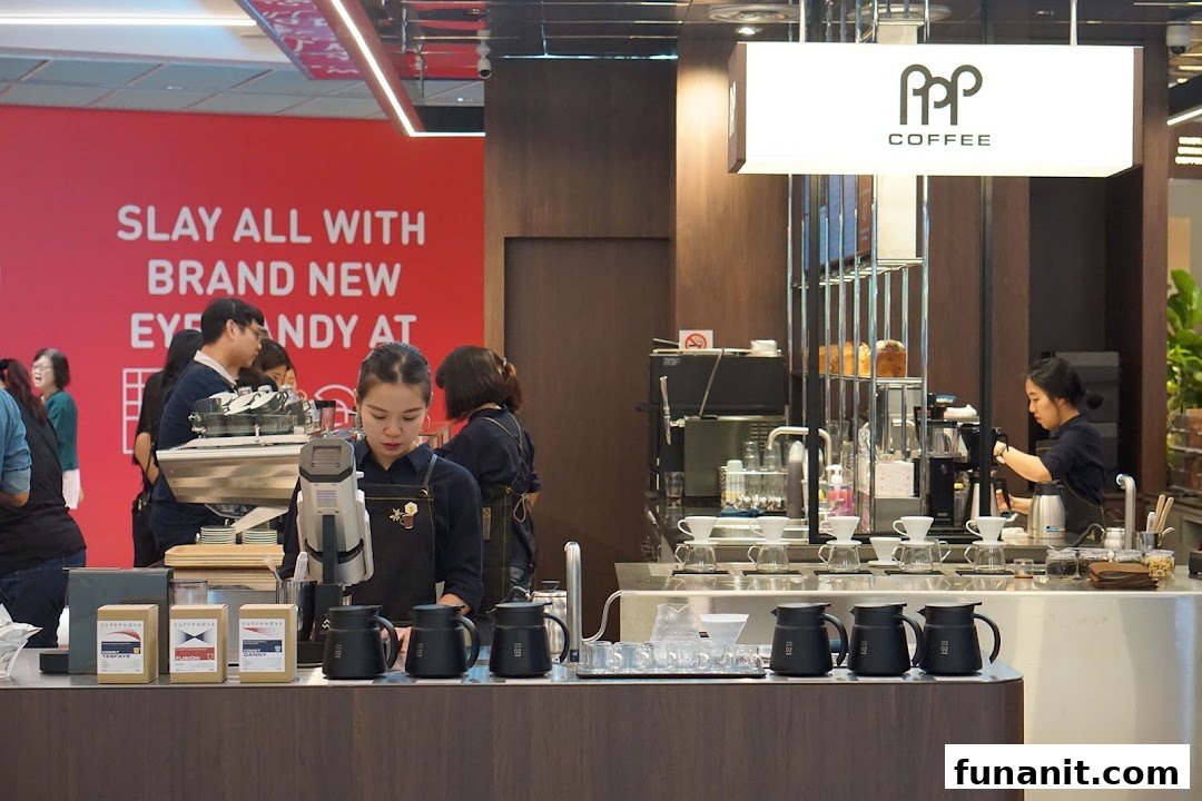 Baristas expertly prepare coffee at PPP Coffee's modern counter, showcasing brewing equipment and coffee products.