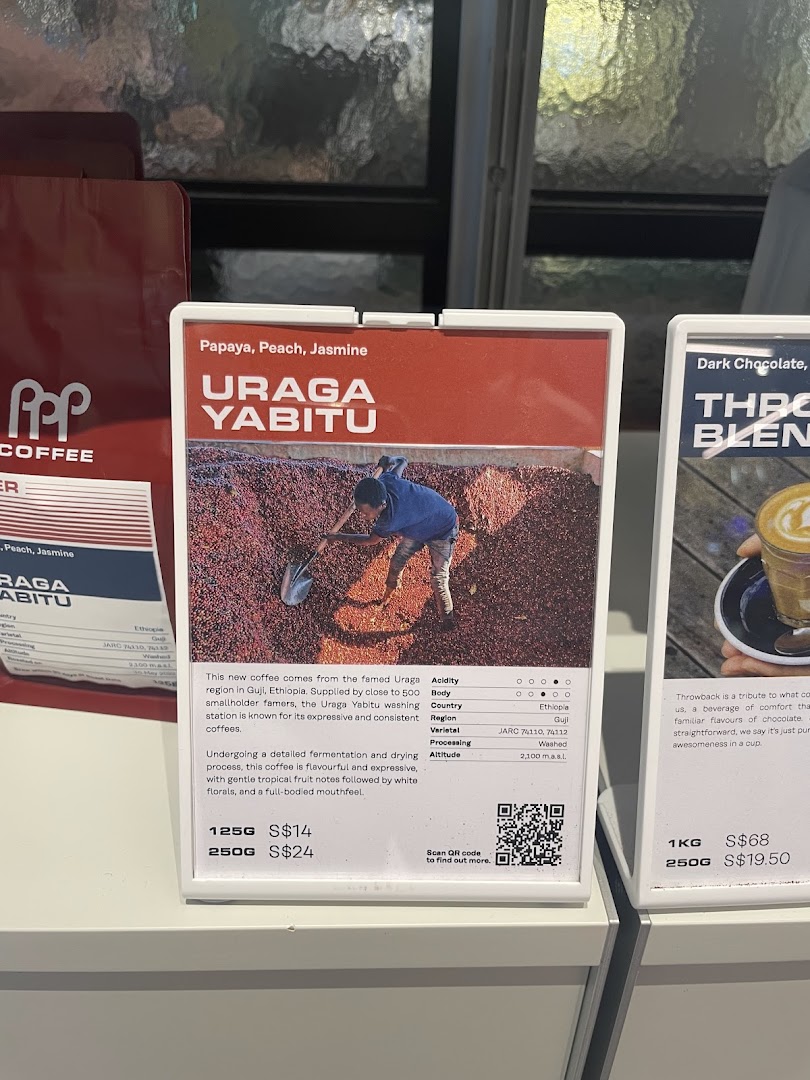 Close-up of coffee bean product displays, featuring Uraga Yabitu and Throwback blends with detailed descriptions and prices.
