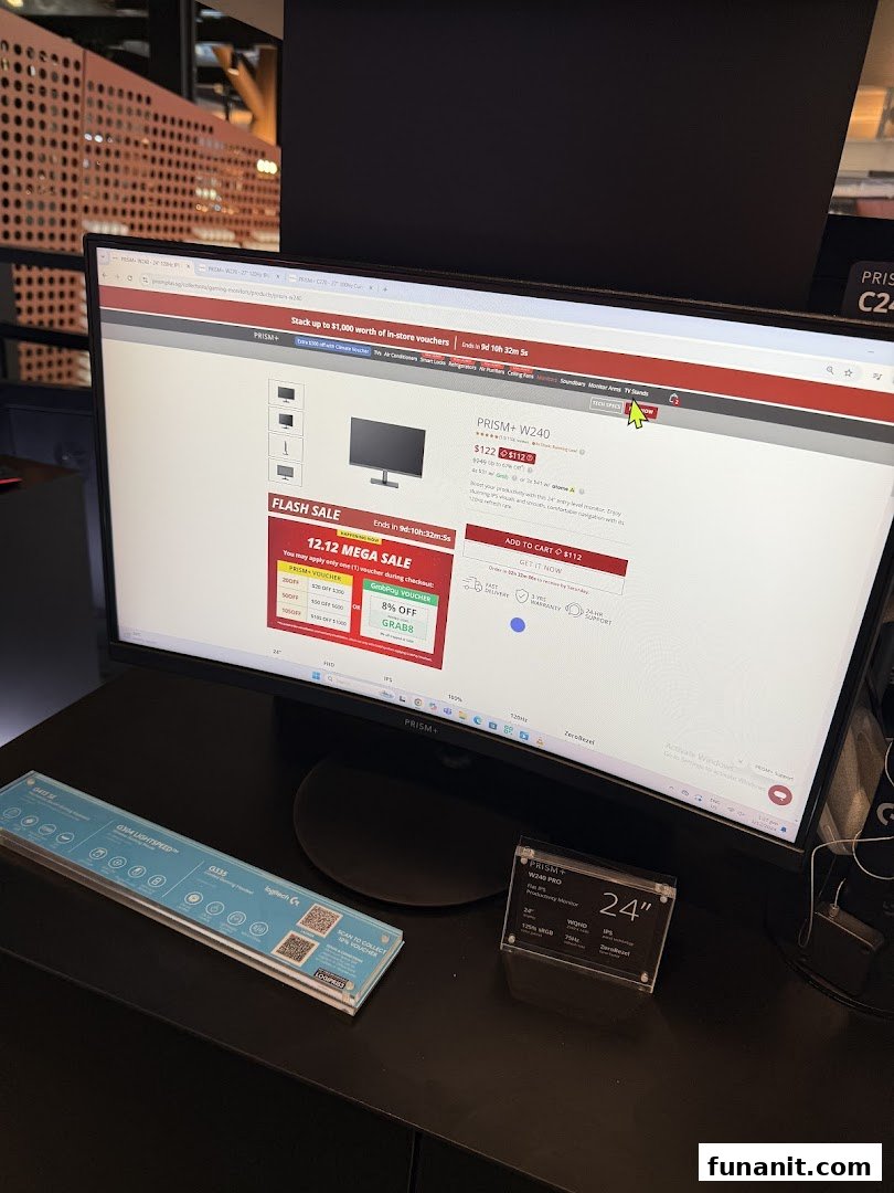 A PRISM+ monitor displaying a product page with flash sale details, alongside other tech accessories.
