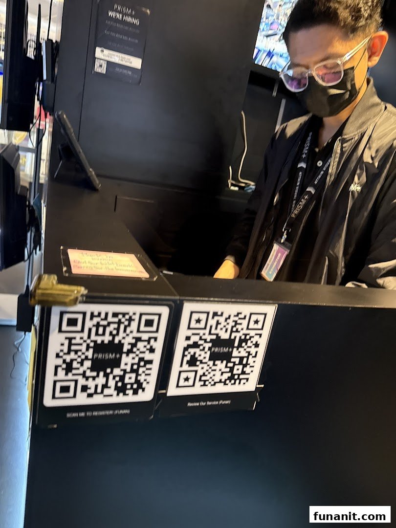 A staff member at the PRISM Funan counter, with QR codes for registration and service review.