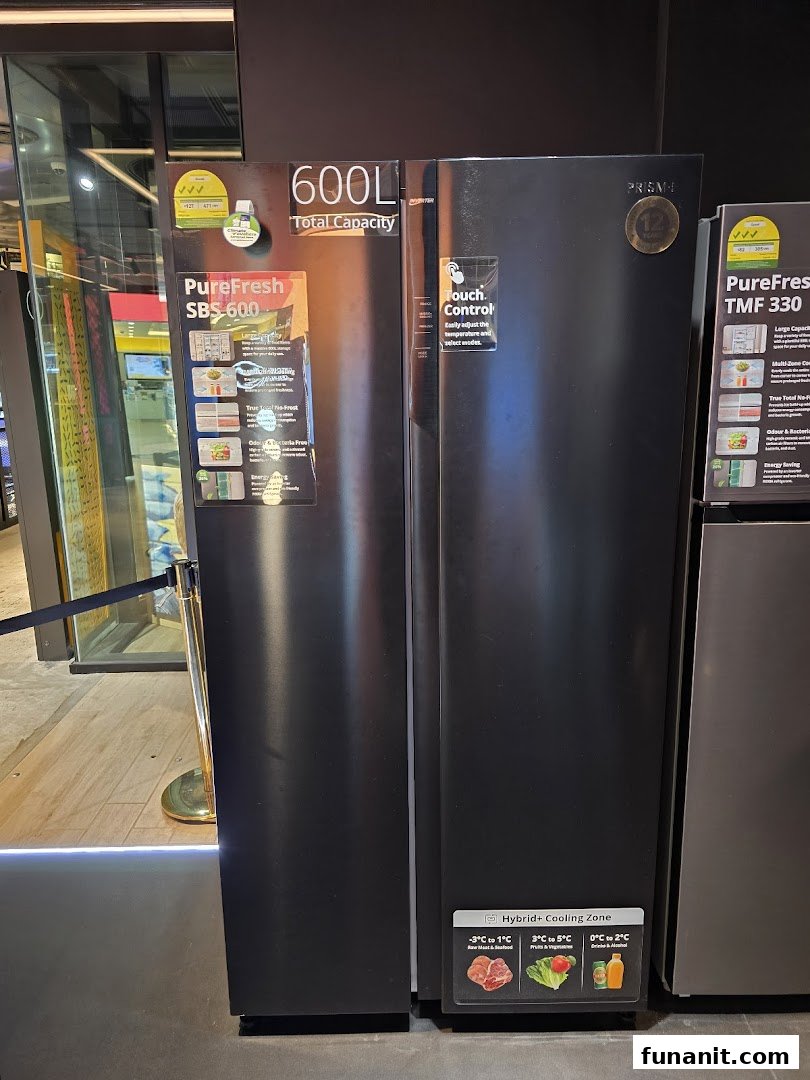 A display of large black refrigerators with product specifications and features visible in a retail store.
