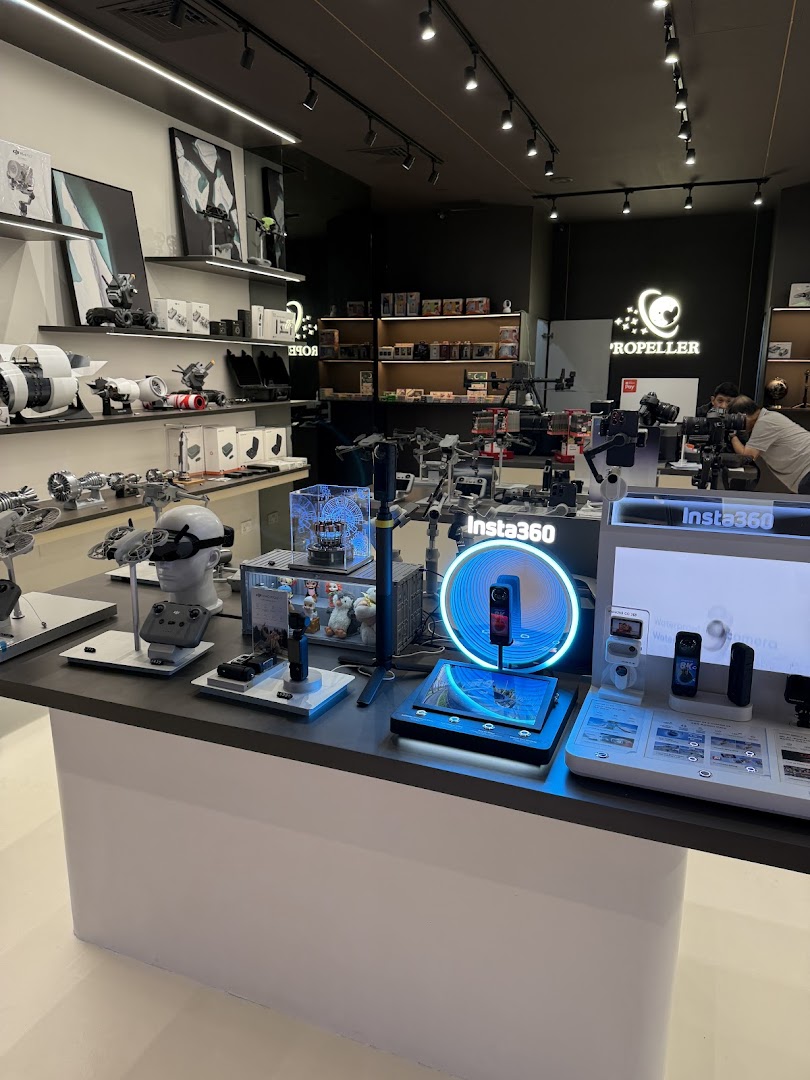 Interior view of Propeller - Funan, showcasing drones, cameras, and tech gadgets on display.