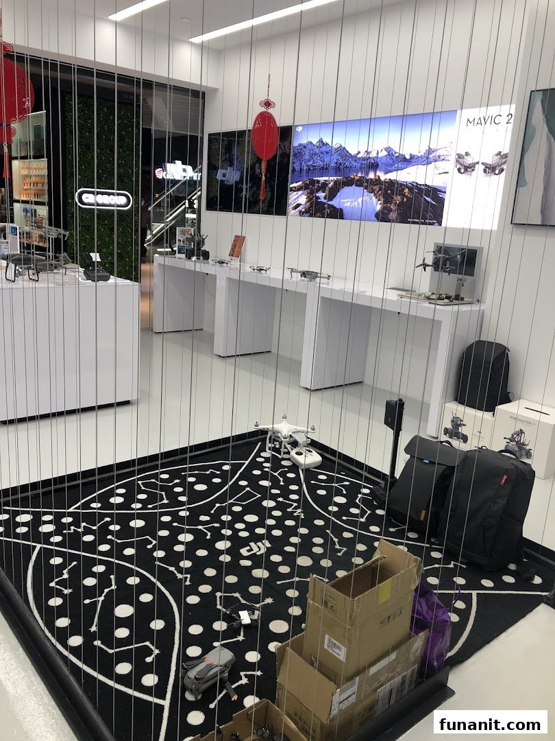 An interior view of Propeller - Funan, showcasing DJI drones and accessories in a modern, brightly lit retail space.