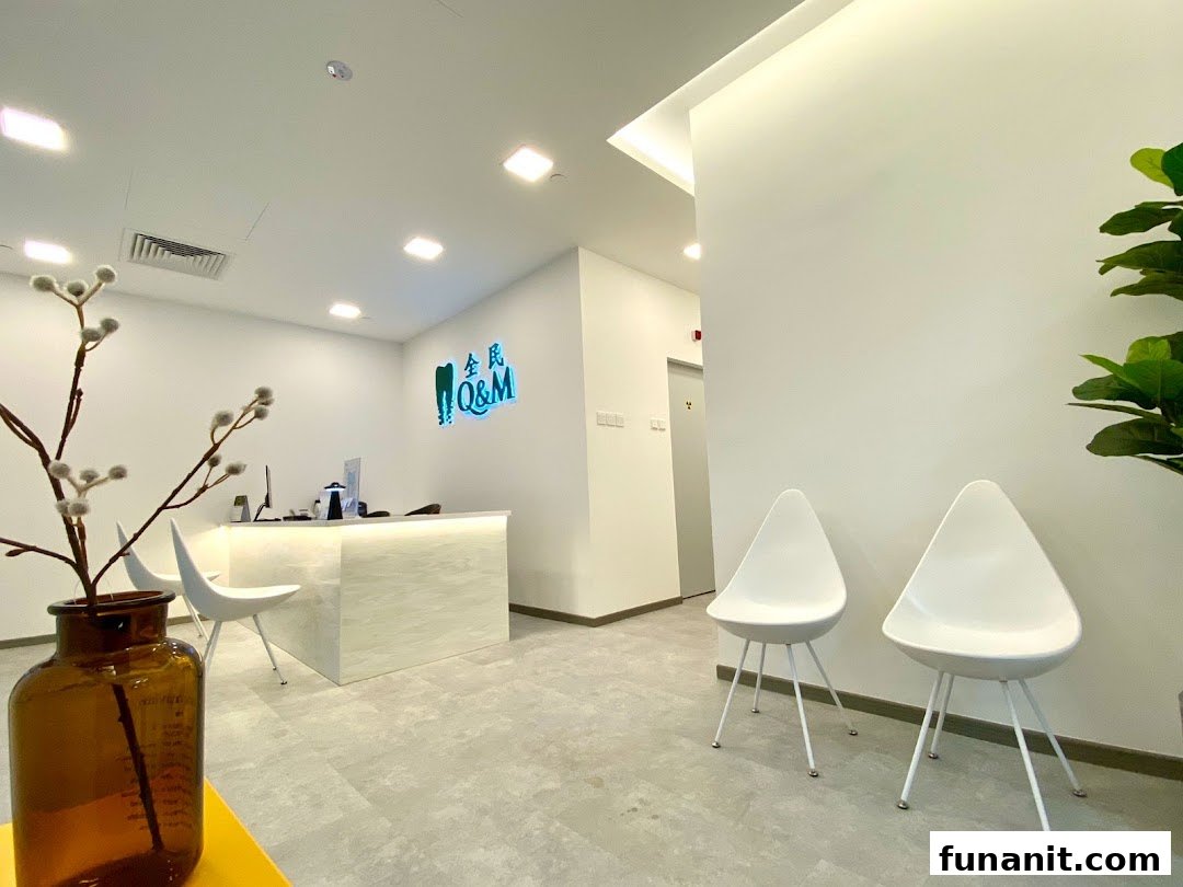 A modern and clean reception area of Q&M Dental Centre with a reception desk and waiting chairs.