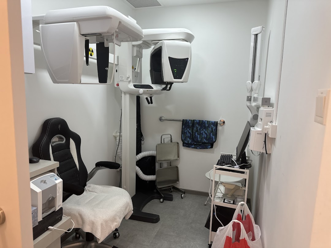 Interior view of a modern dental clinic examination room with advanced imaging equipment.