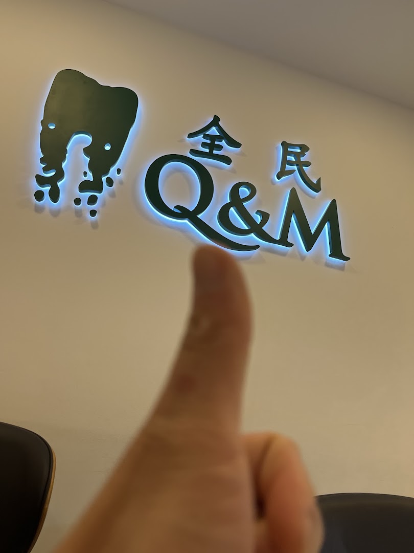 The Q&M Dental Centre logo with a glowing effect and a thumbs-up gesture.