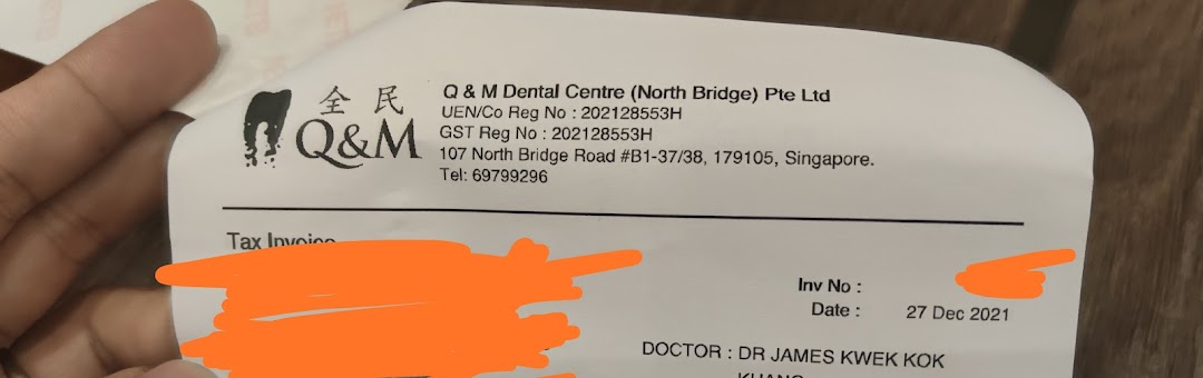 A close-up of an invoice from Q & M Dental Centre (North Bridge) Pte Ltd.