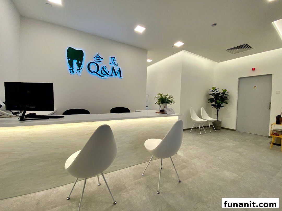 A modern and clean reception area of Q&M Dental Centre with a bright logo and seating.