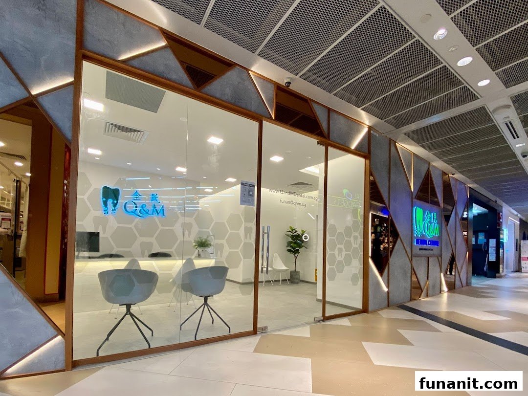 Modern exterior of Q&M Dental Centre with a glass facade and geometric design.