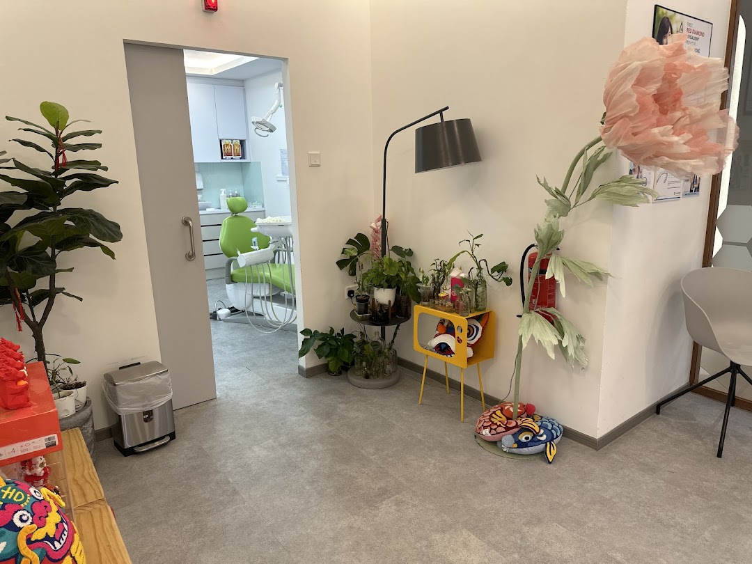 A modern dental clinic interior, showing a waiting area with a glimpse into a treatment room.