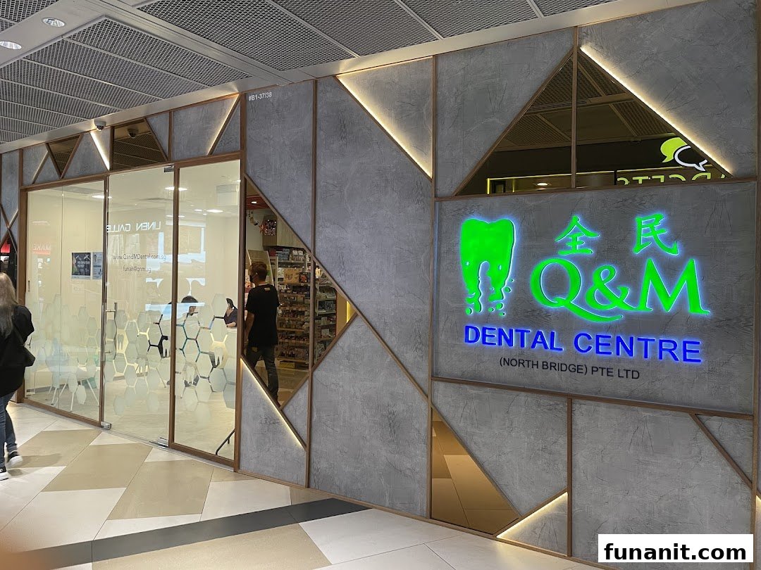 Exterior view of Q&M Dental Centre North Bridge-Funan with its illuminated sign and glass entrance.