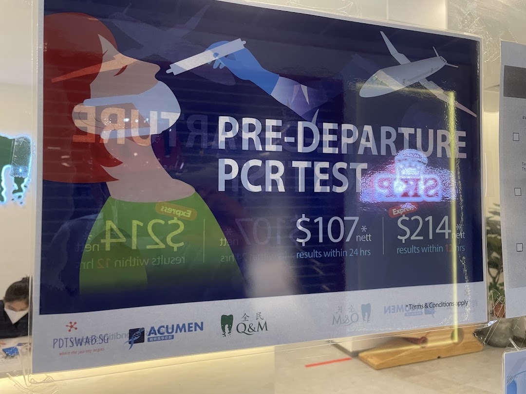 A sign advertising pre-departure PCR tests with pricing and turnaround times at Q&M Dental Centre.
