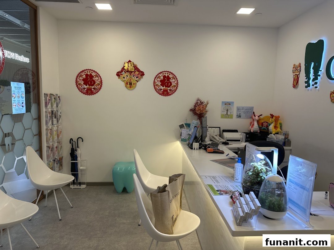 Modern dental clinic reception area with white counter, seating, and festive decorations.