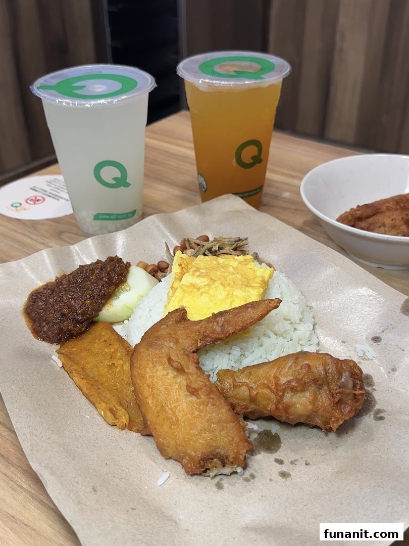 A delicious plate of Nasi Lemak with fried chicken and two refreshing drinks from Qi Ji.