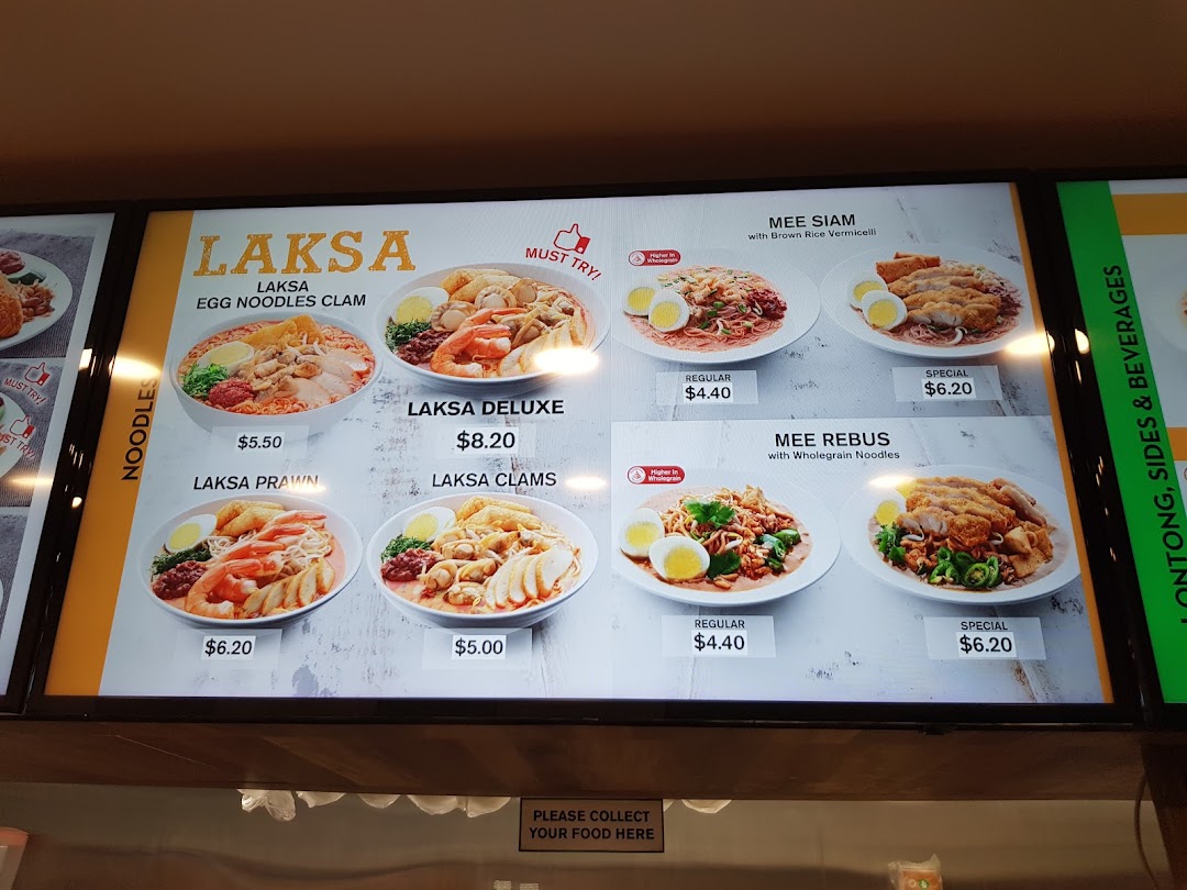 A digital menu board displaying various Laksa and Noodle dishes with prices and images.