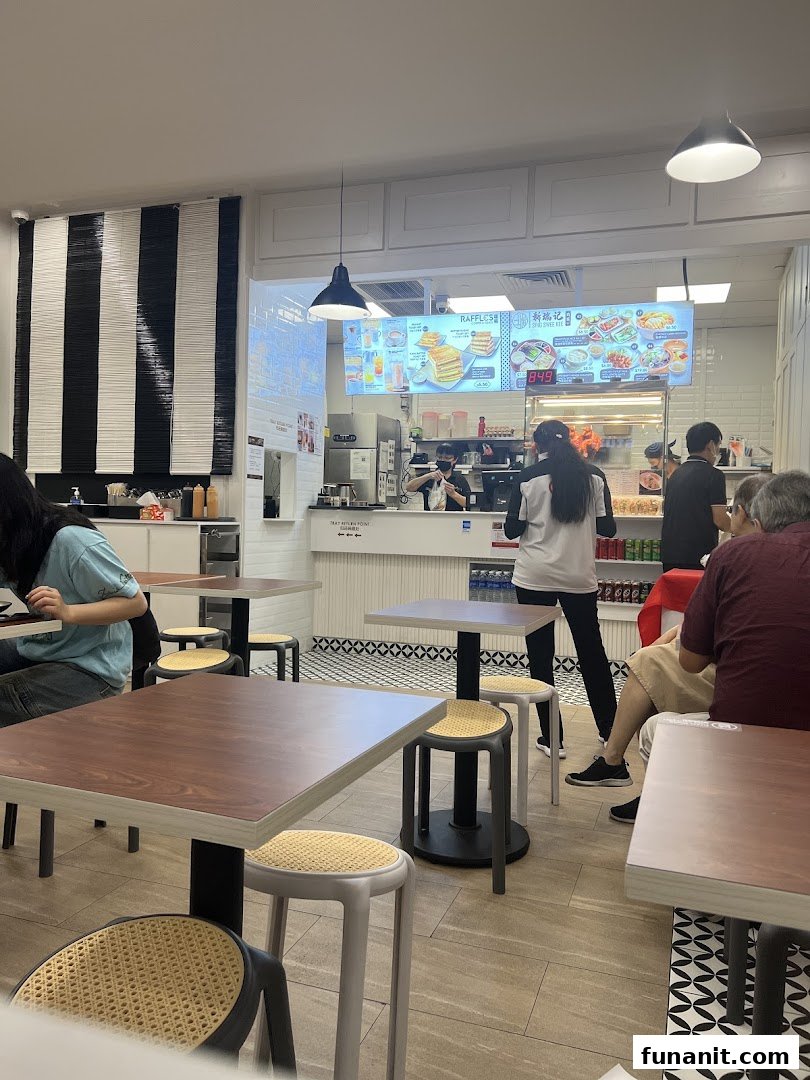 Interior view of Raffles Coffee and Toast, showing customers, staff, and the counter area.